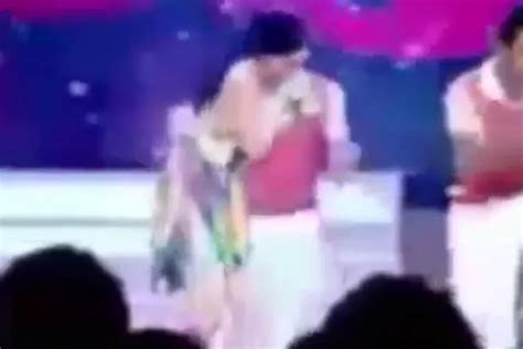 Excruciating moment pop star's boob pops out live on kids TV in .